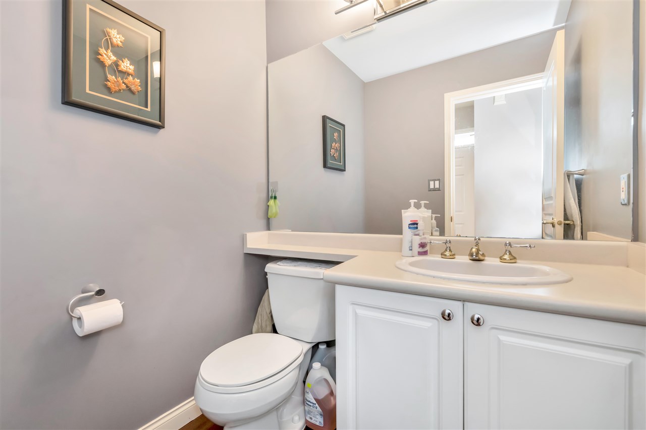The second bathroom, a vanity and mirror under a sloped ceiling.