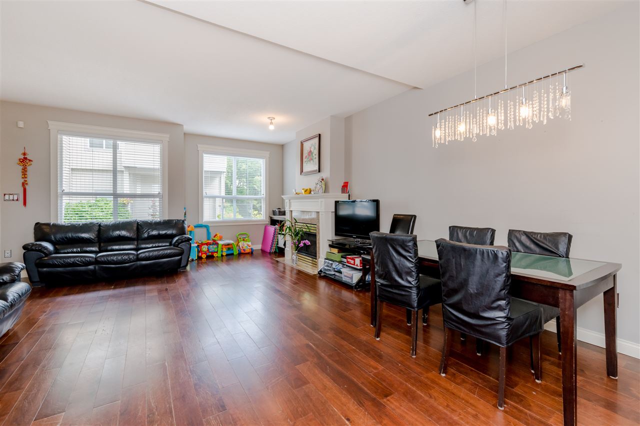 The living and dining rooms together, hardwood running the length of the floor.