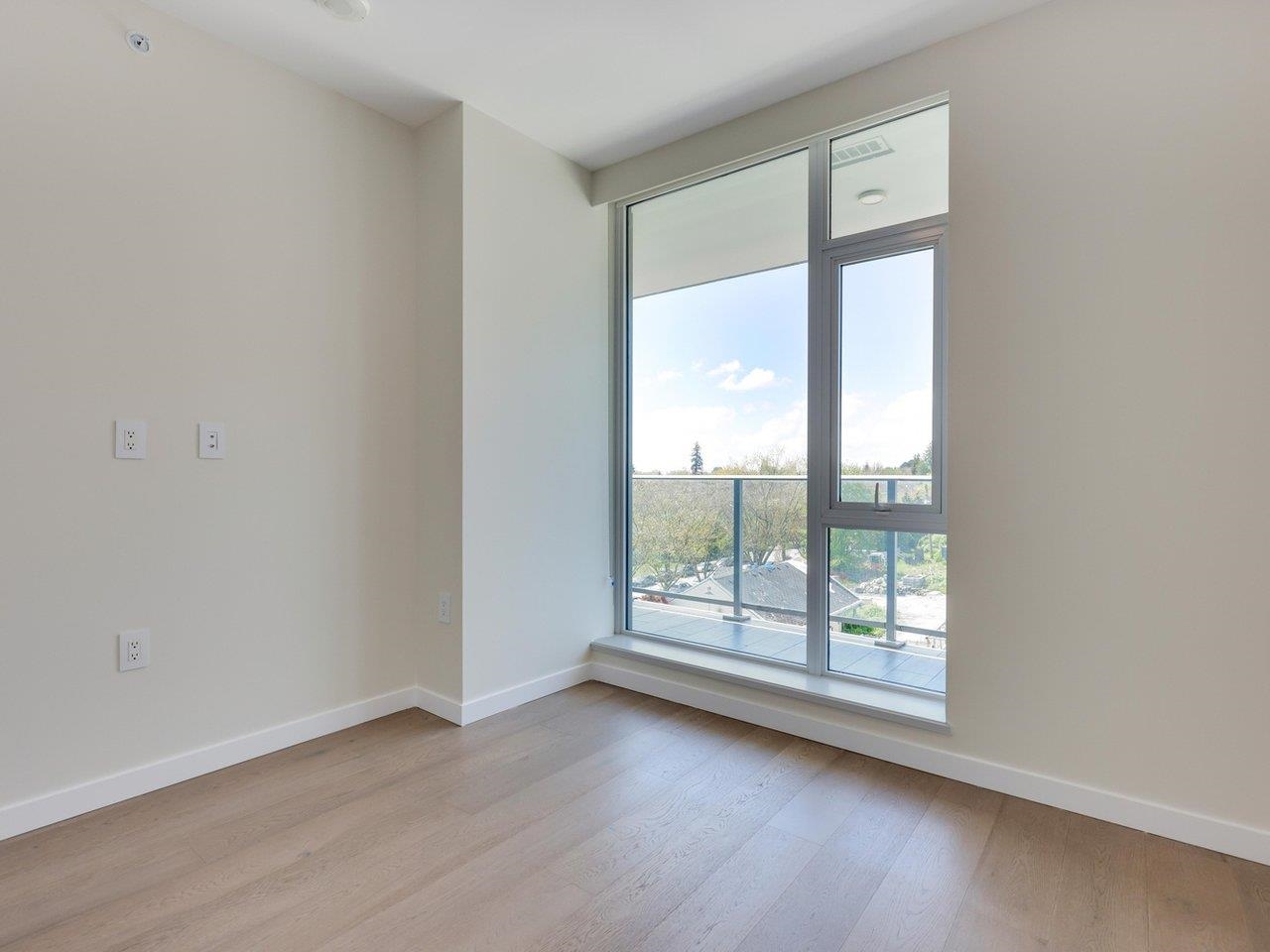 The bedroom, with a tall window and a low sill looking west over the neighbourhood.
