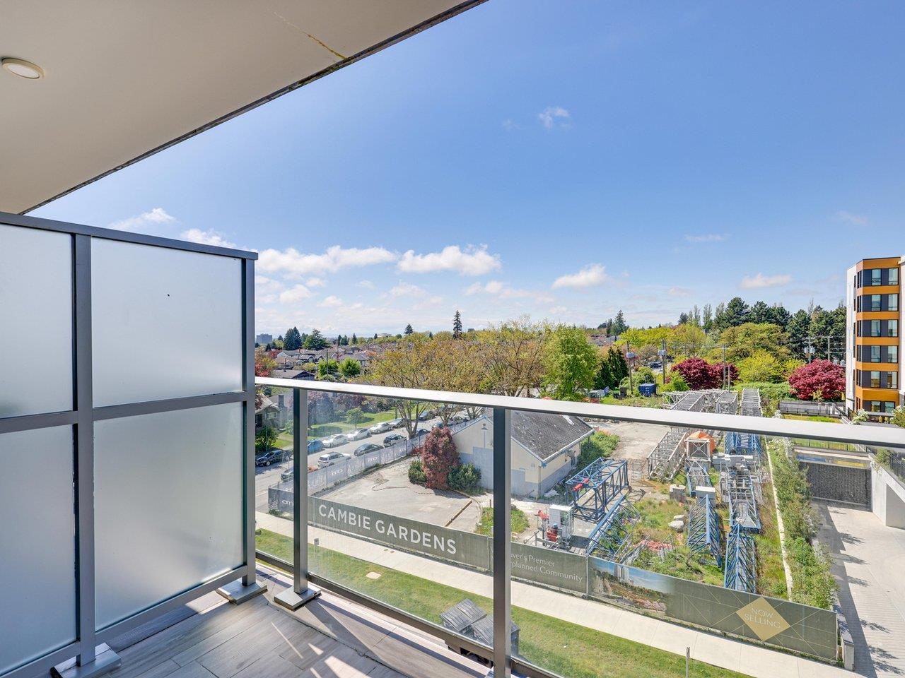 The covered balcony looking out over the Cambie Gardens courtyard and the buildings around it.