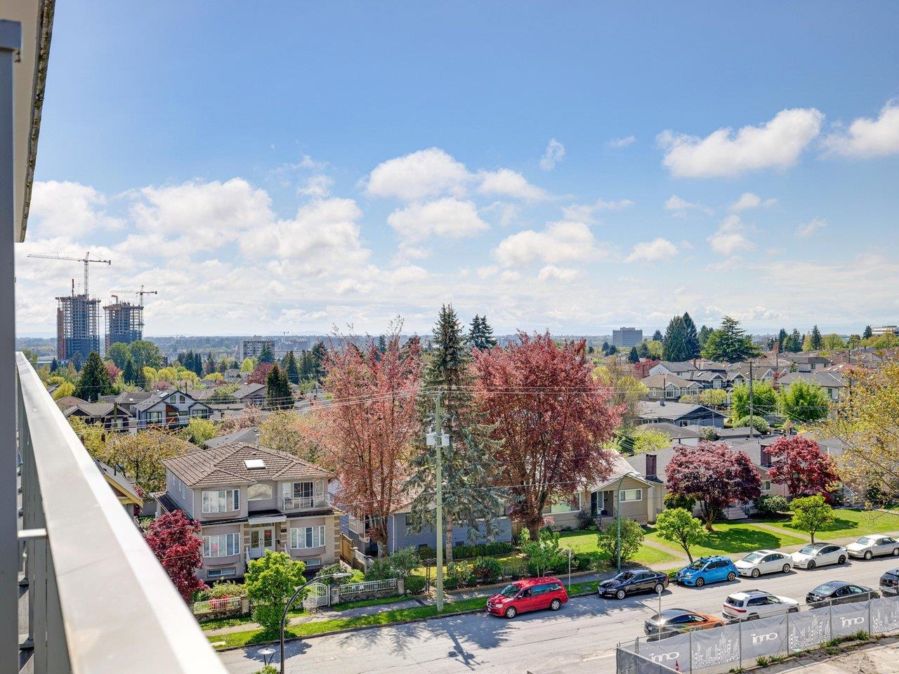 The view west from the balcony, across the rooftops and trees of the neighbourhood towards the city.