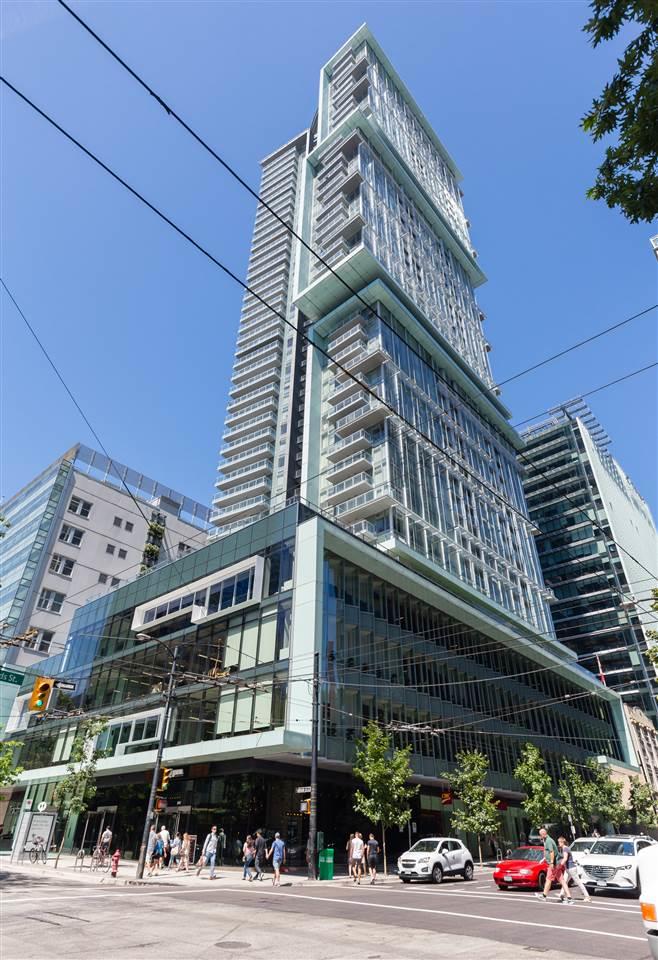 Telus Garden from the street corner, the glass tower rising above the retail podium with the sidewalk busy below.