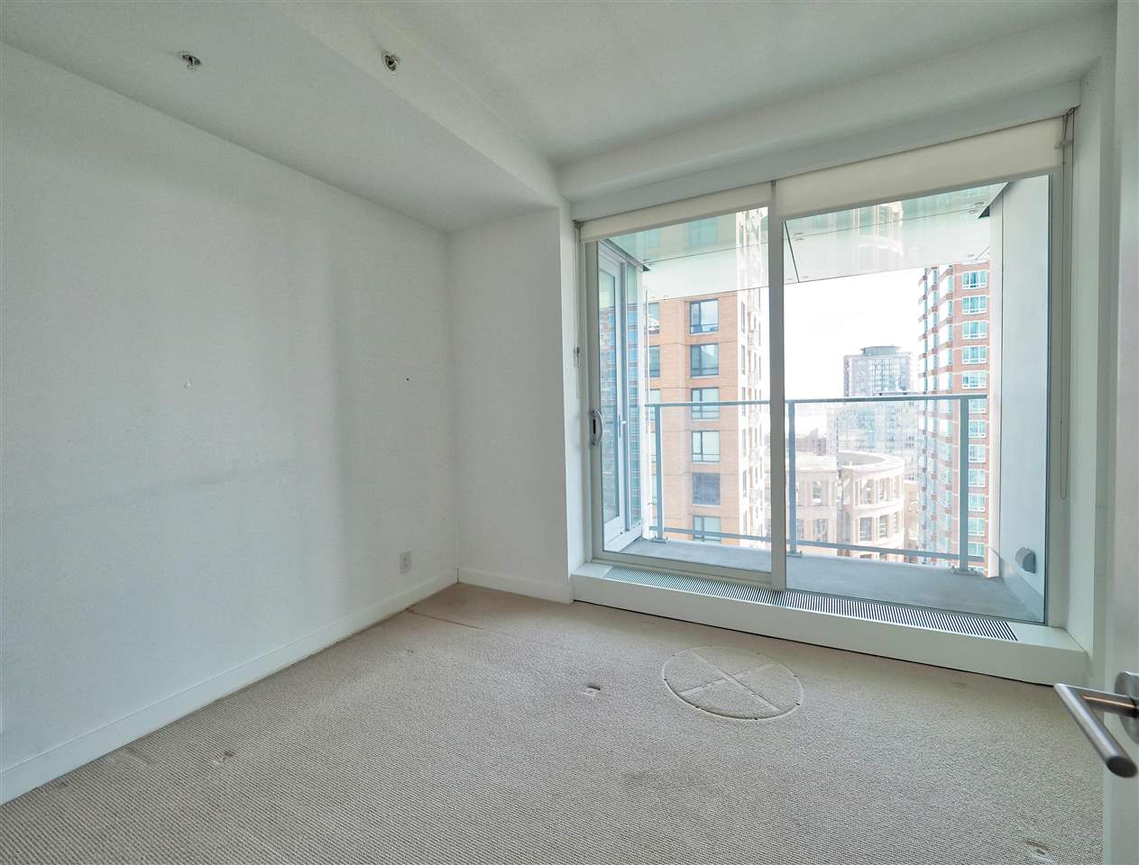 The second bedroom, the window wall filling one side of the room.