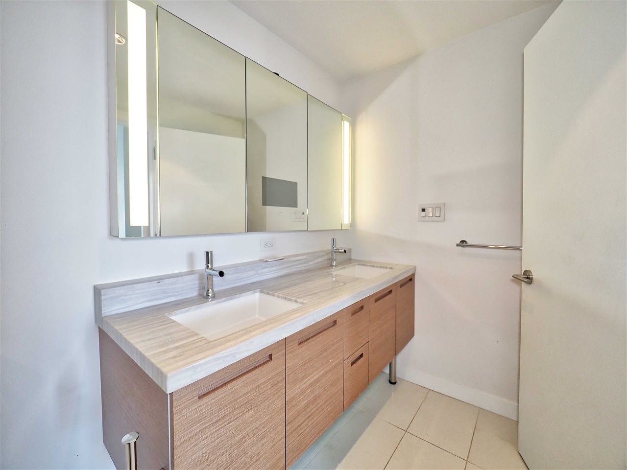 The main bathroom, a double vanity in timber under a long mirror.