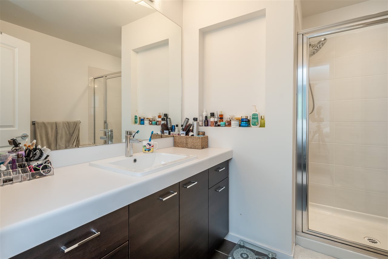 The bathroom, a long double vanity beside a glass shower.