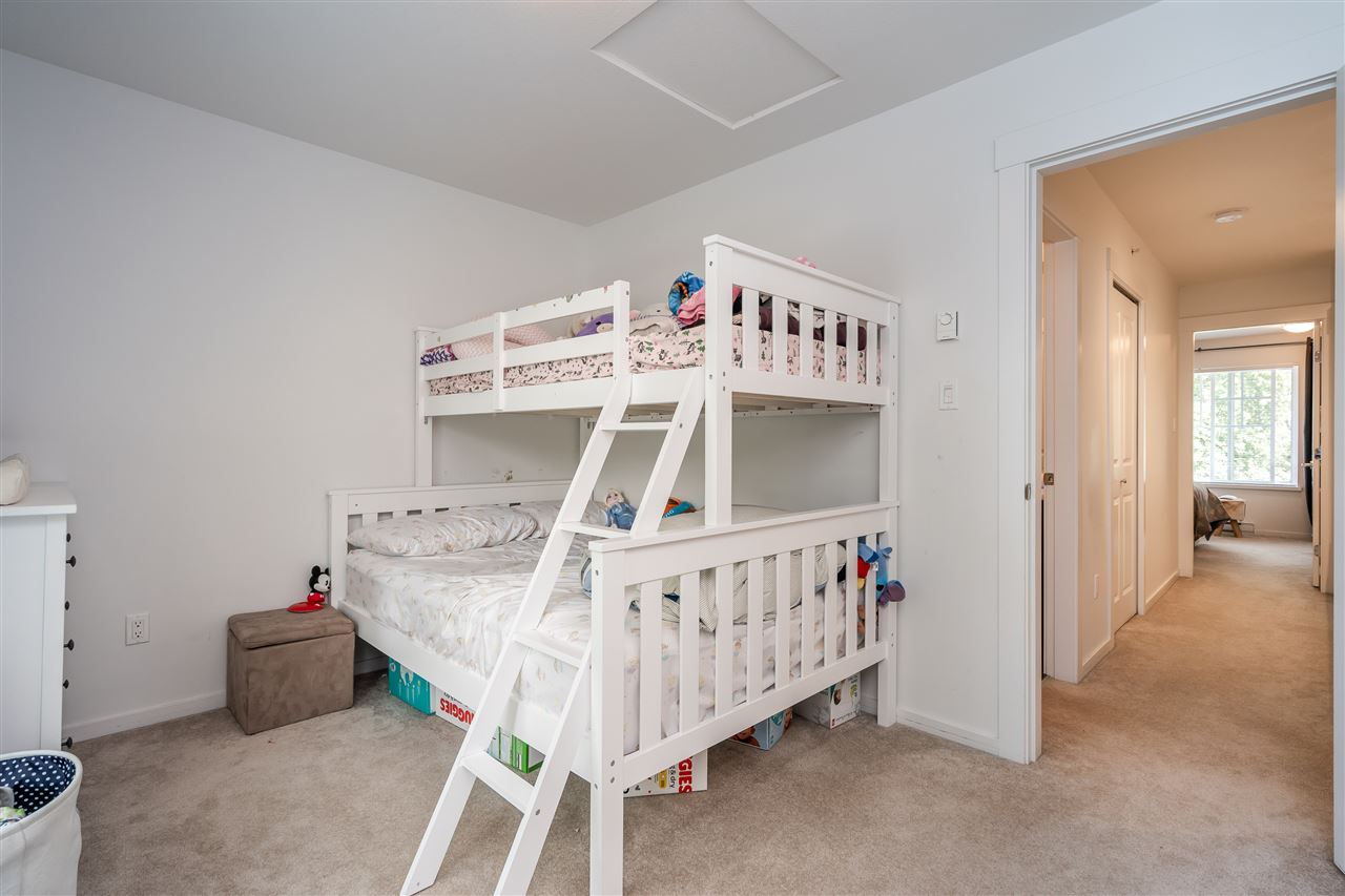 The second bedroom, a bunk bed with a ladder against the wall.