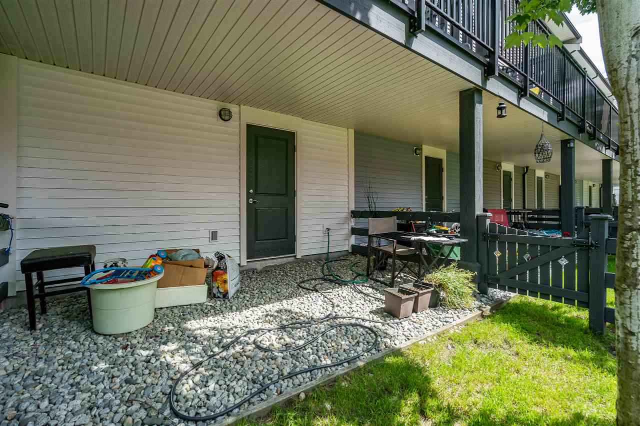 The patio running along the back of the homes, doors opening onto it.