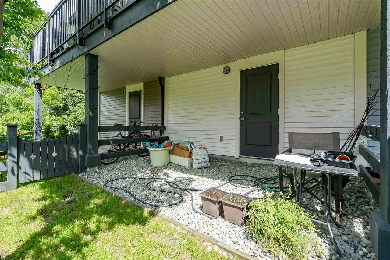 The back door onto the patio, with the yard in front of it.