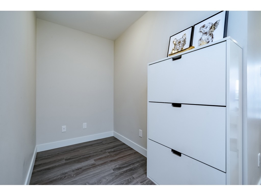 The den, a small squared room off the plan with a cabinet against the far wall.