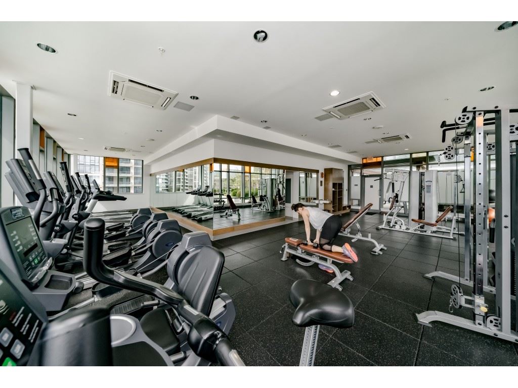 The exercise centre, rows of machines and free weights along a glazed wall.