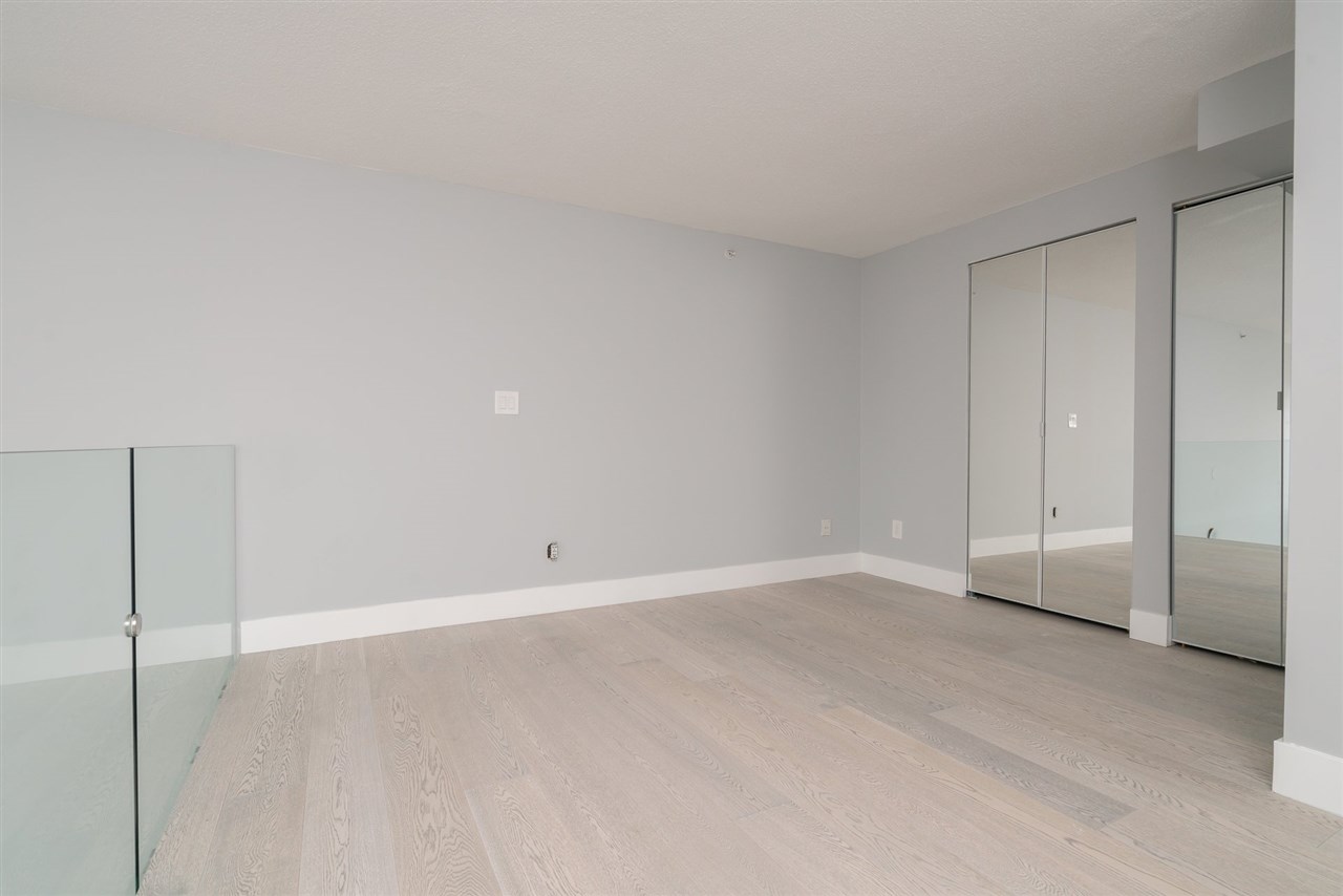 The sleeping loft upstairs, mirrored closet doors running along one wall.