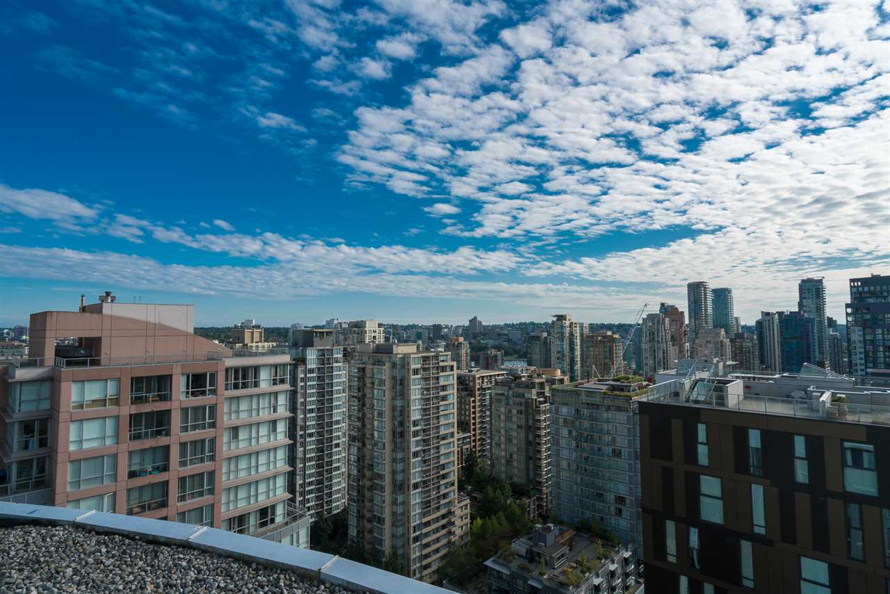 The city from the rooftop terrace, rooftops and towers under a wide sky.