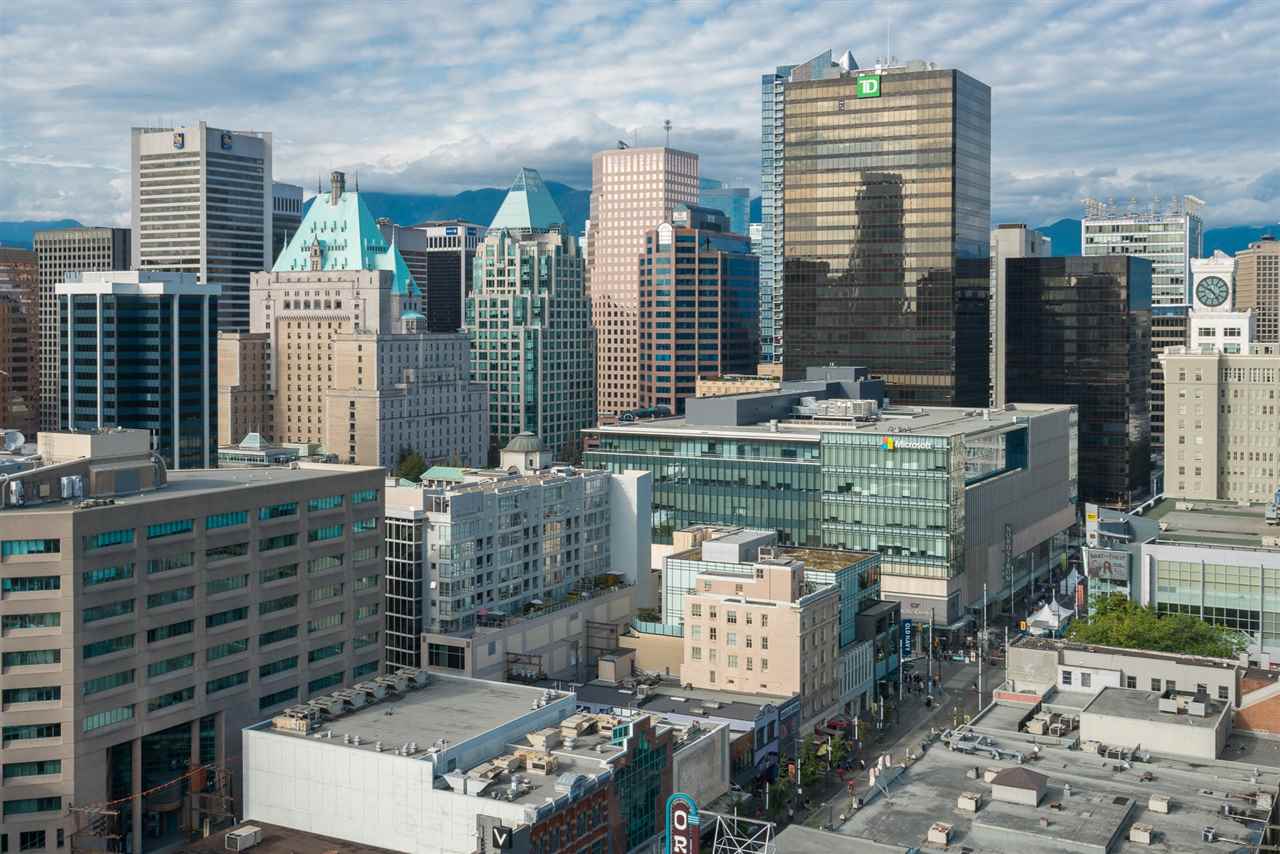 The skyline from the rooftop terrace, the office towers standing over the older blocks.