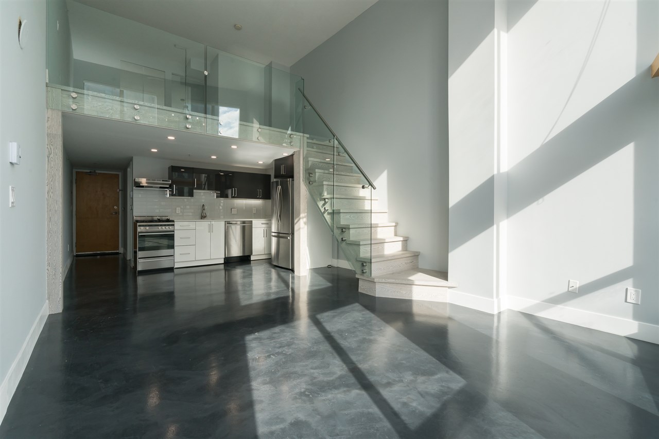 Looking back from the windows across the main floor to the kitchen and the stair.