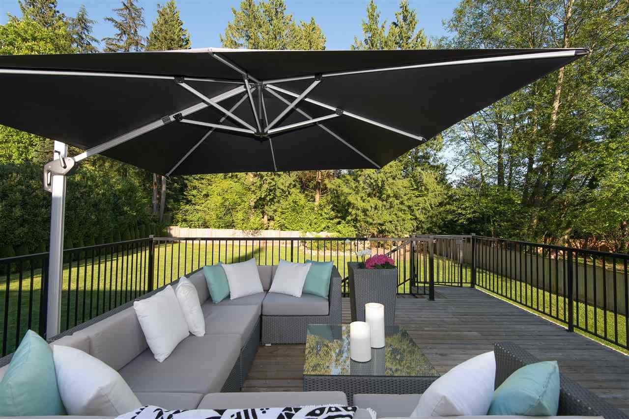 The deck, an outdoor sectional under a large cantilevered umbrella.
