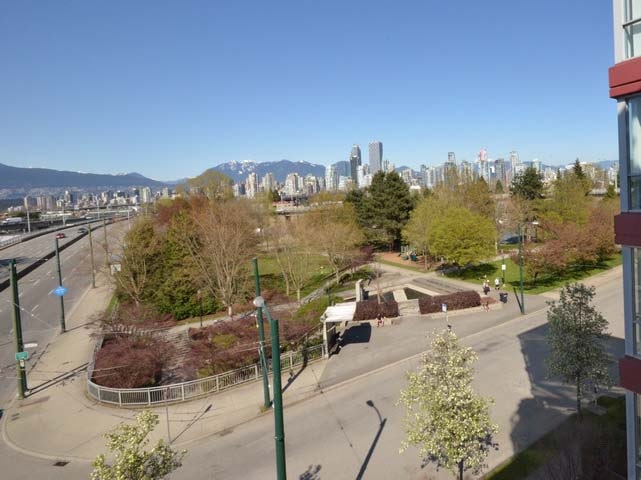 The view from the flat, the park and its trees below and the downtown towers along the water beyond.