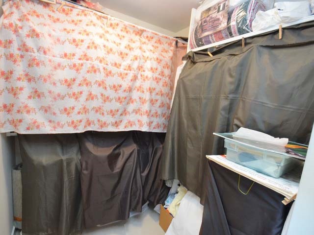 The walk-in closet off the primary bedroom, hanging space along both sides.