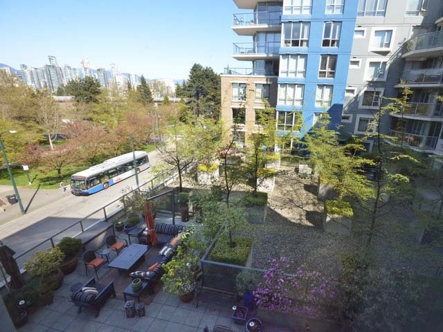 The view down into the building's courtyard garden, seating under the trees.