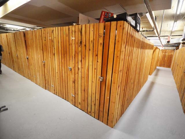 One of the storage lockers, cedar-slatted walls under the garage ceiling.