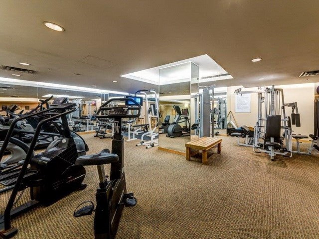 The exercise centre, treadmills and weight machines along the room.