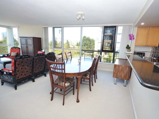The dining and living rooms together, the wall of windows running the length of both.